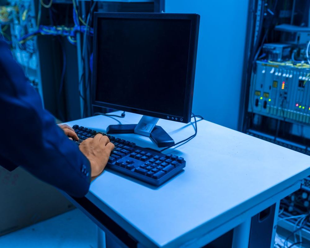Technician at a console in a server room